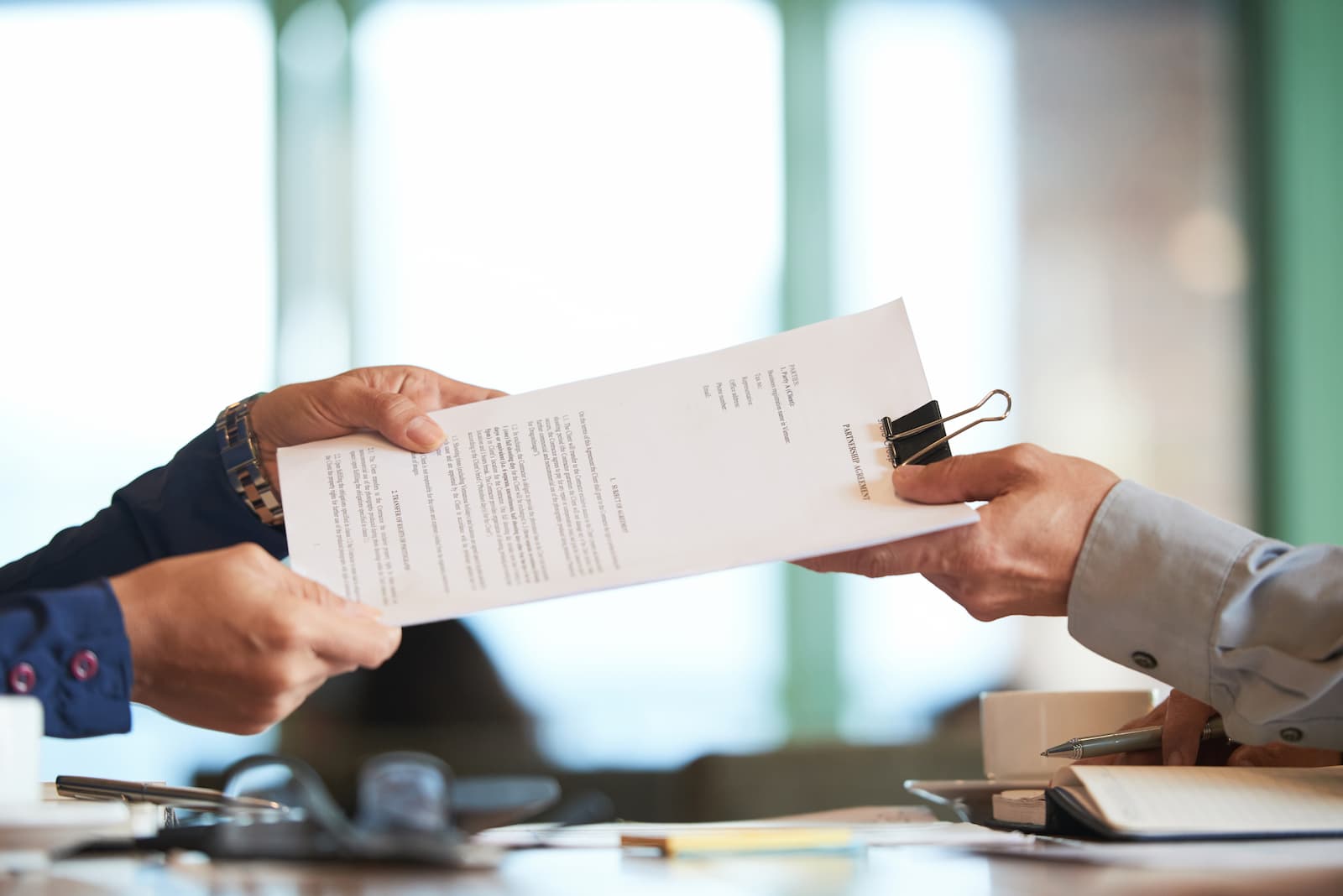 closeup-hands-passing-contract-unrecognizable-businessman